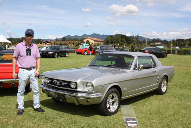 Nicolas Pelaez stands next to the 1966 Mustang that used to belong to his great grandfather. 