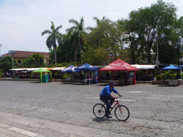 As he rides by, behind him, the Saturday market in Santa Fé de Antioquia is almost ready for business.