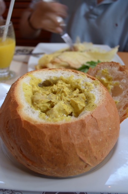 A bread bowl (panne cook) with chicken in curry sauce. 