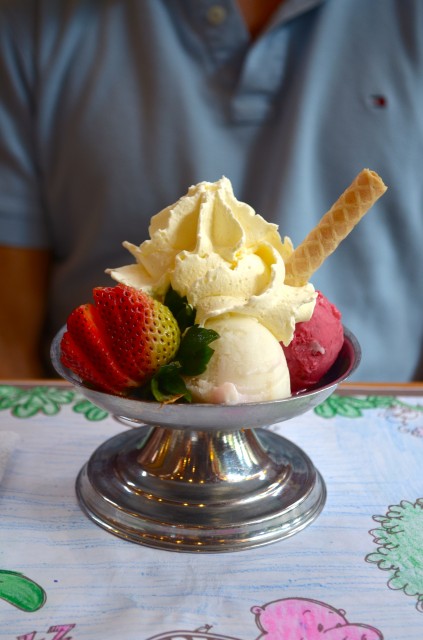 Hawaii ice-cream. Scoops of guanabana , mango and mora (raspberry) with whipped cream and topped of with a strawberry.