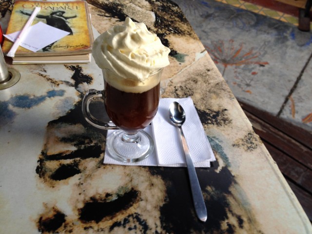 A tasty beverage made with coffee, amaretto and whipped cream