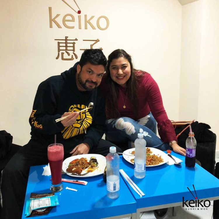 A couple eating in the loungey area in the back of Keiko