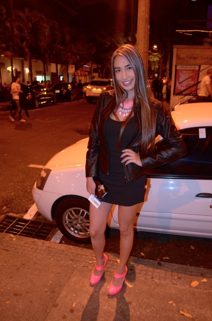 She paired her black dress with neon pink heels.