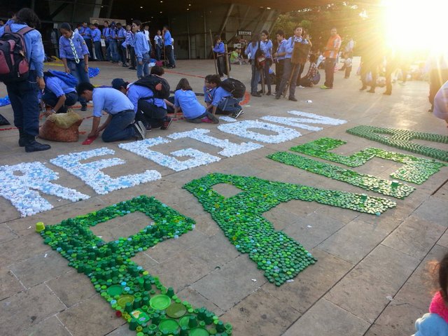 Creating artwork out of bottle caps in the plaza.