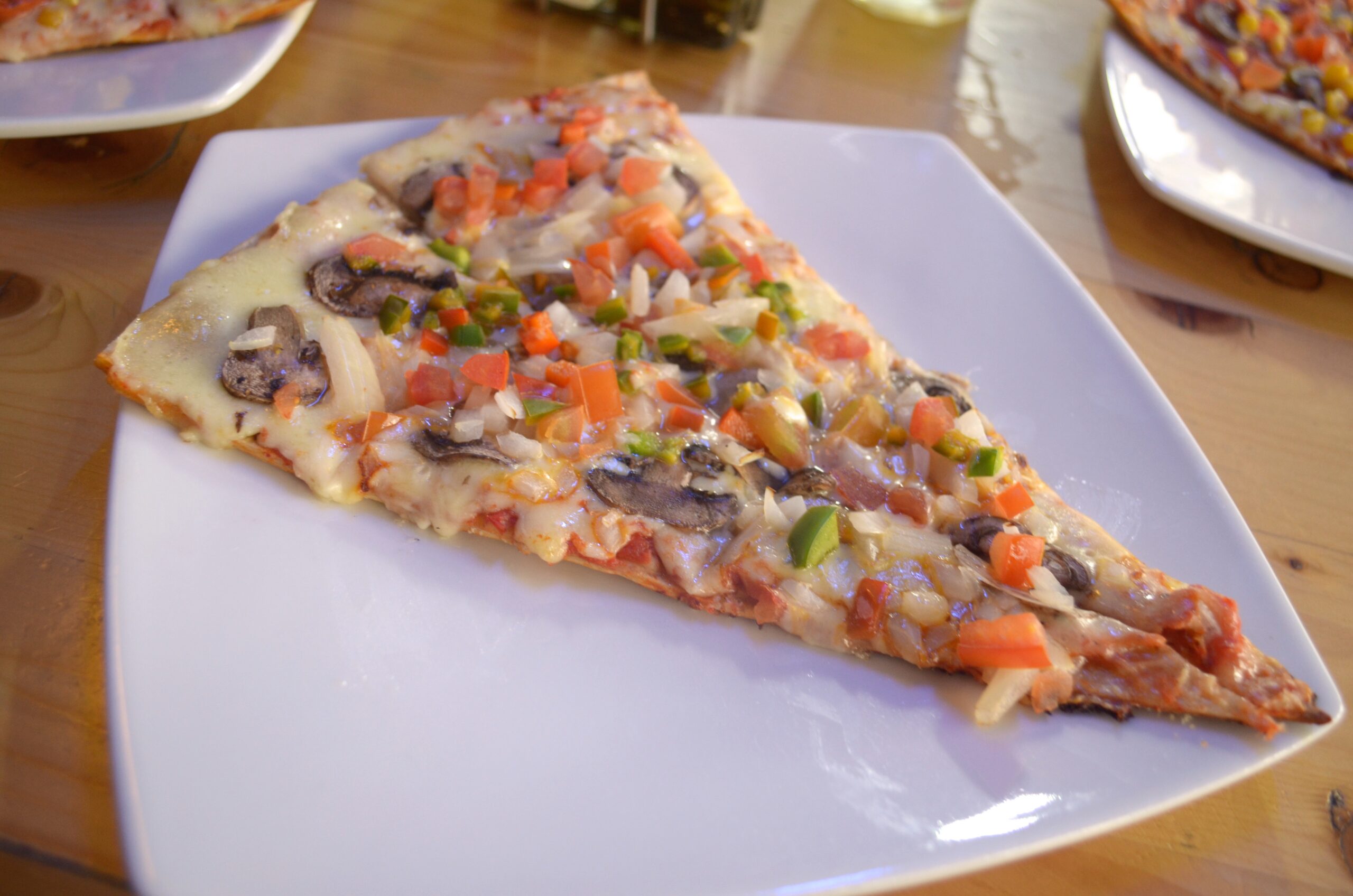 Pizza Completely covered in fresh vegetables like tomatoes, mushrooms, onions and red pepper this slice of vegetarian pizza is 6,800 pesos ($2.50)