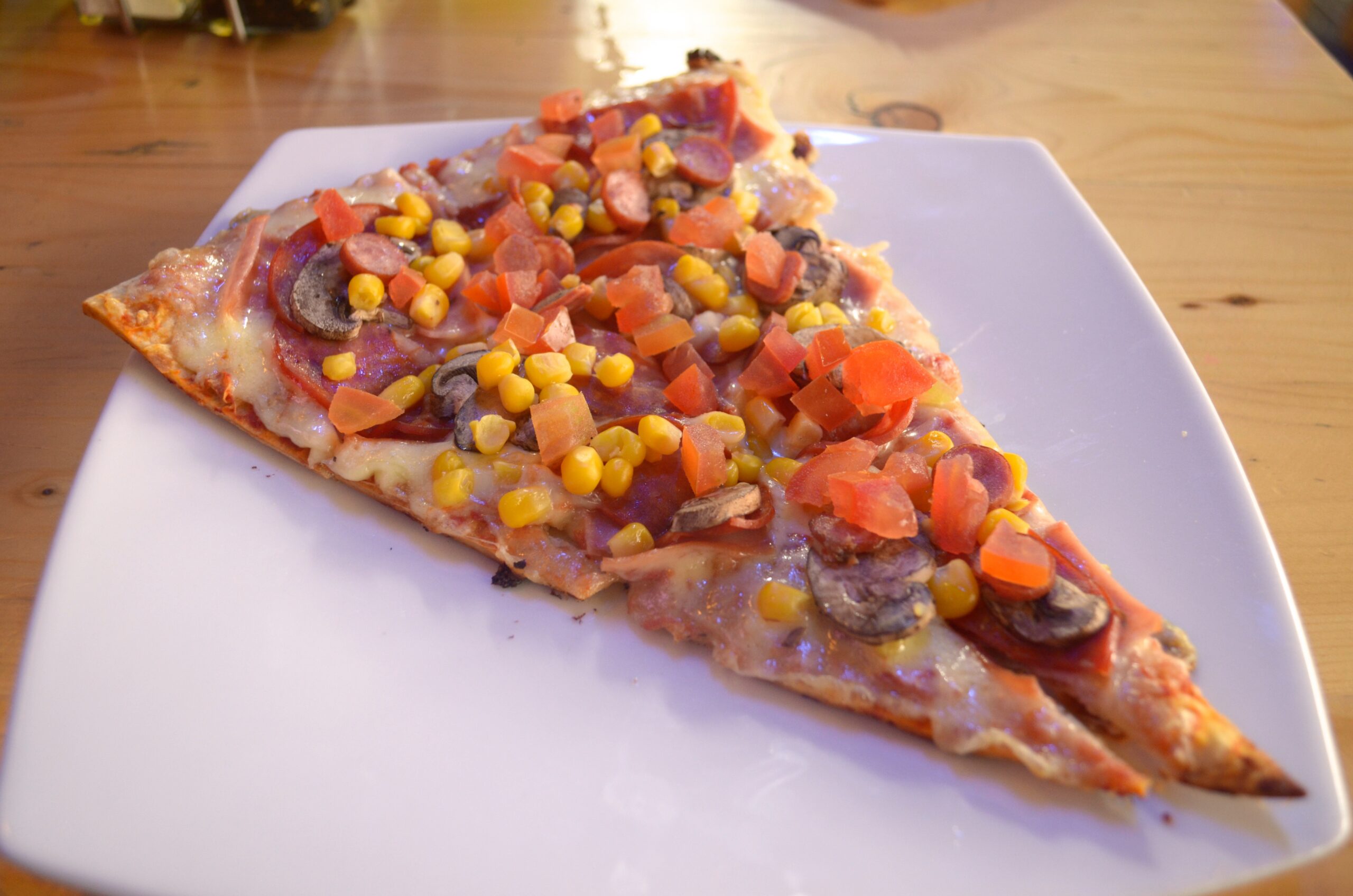 Alejo pizza This slice is named after the owner of the restaurant, Alejo with toppings of sweet corn, ham, pepperoni, tomatoes, mushrooms and cabano for only 9,800 COP ($3.70)