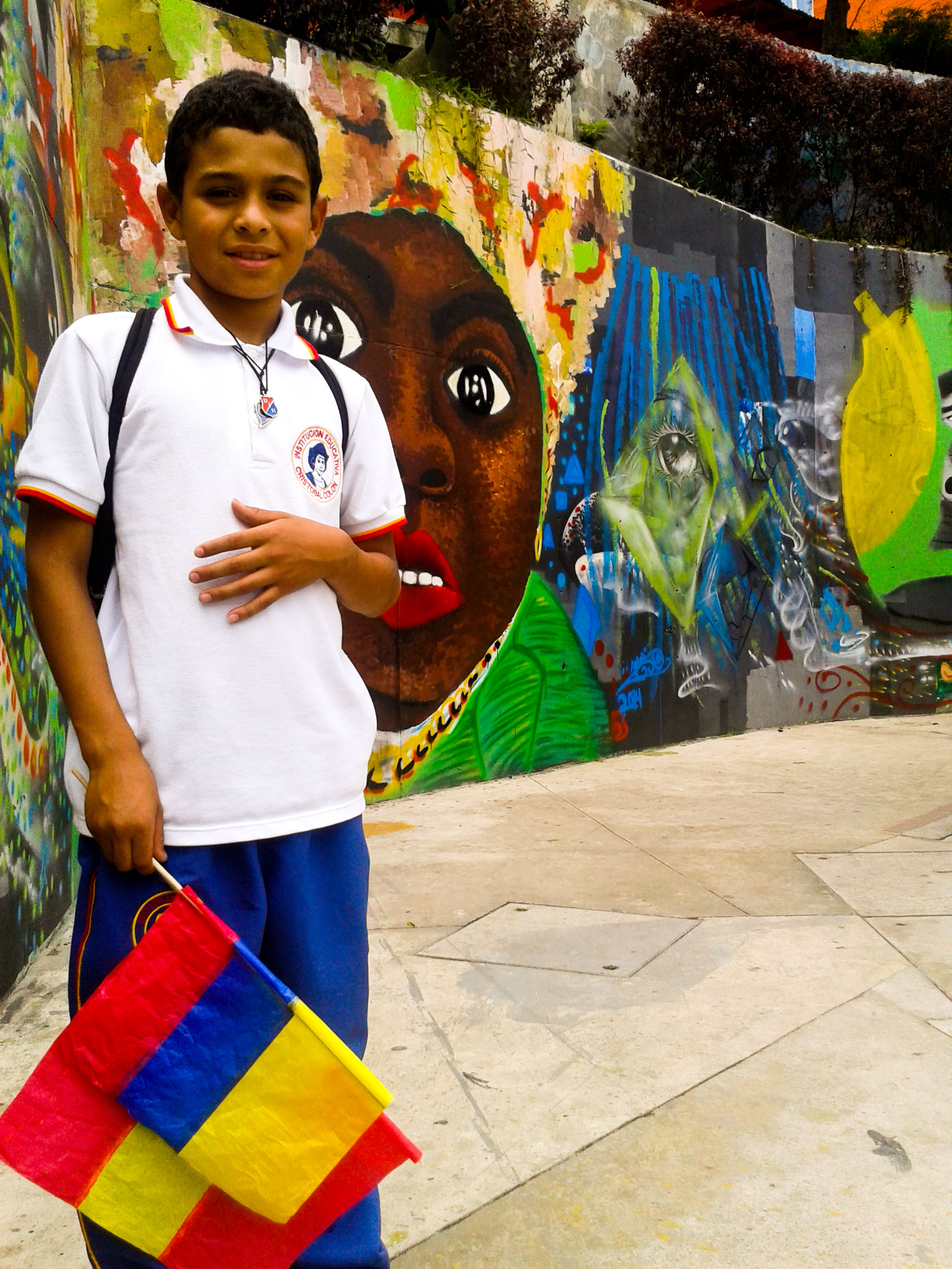 A child, resident of comuna 13, posing for a photo after school.
