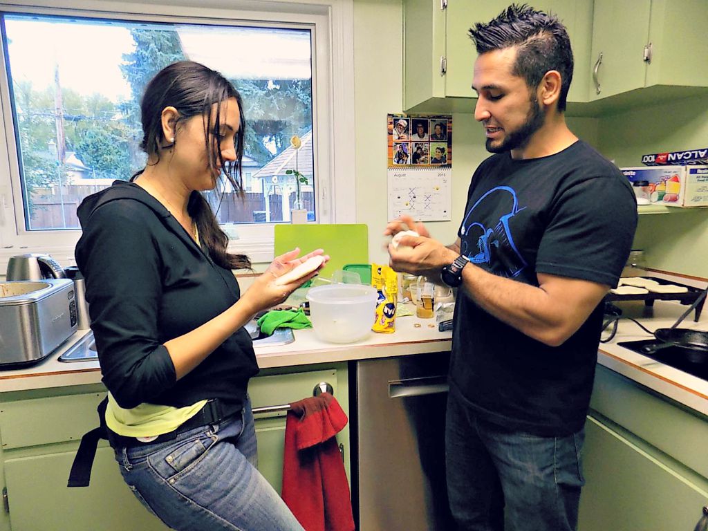 Marta and Andrés making arepas in Saskatoon.