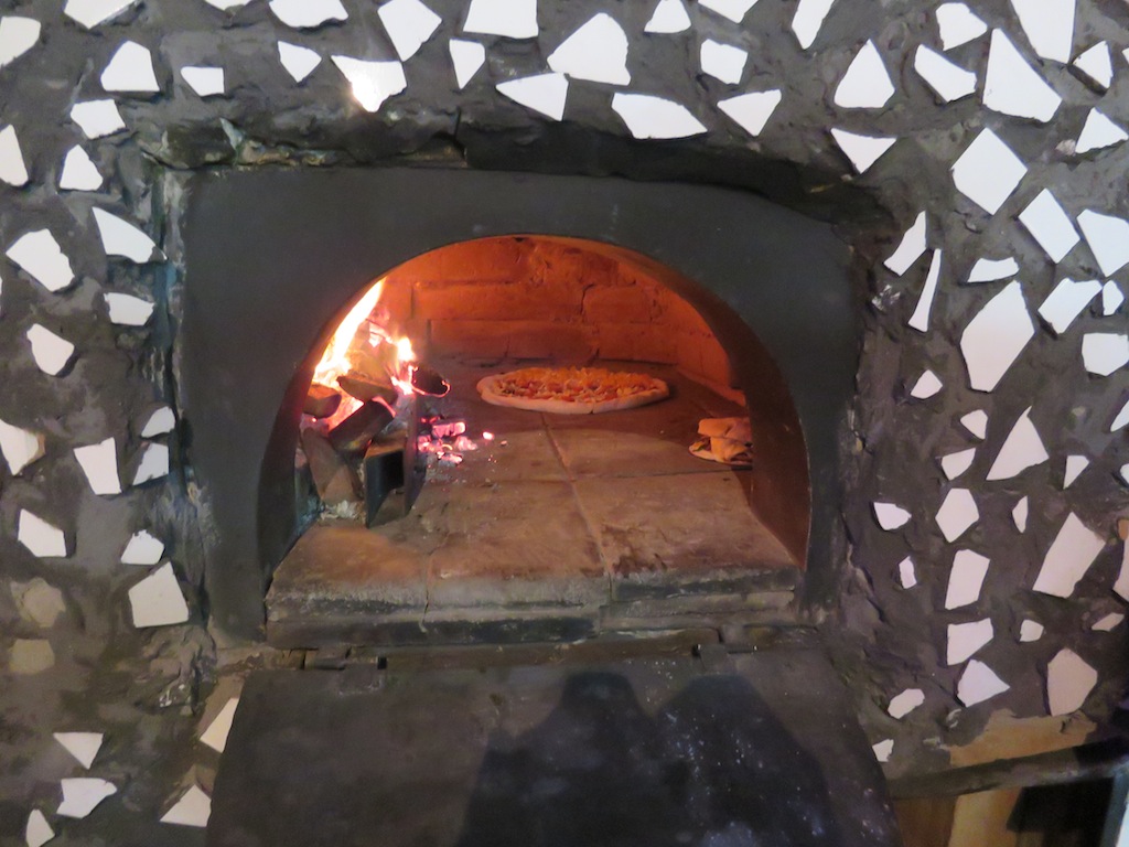 Pizza being cooked in the brick oven