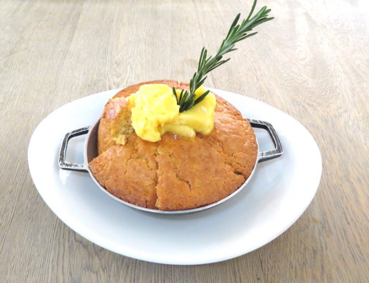 Unforgettable cornbread baked in a cast iron skillet, served with honey butter