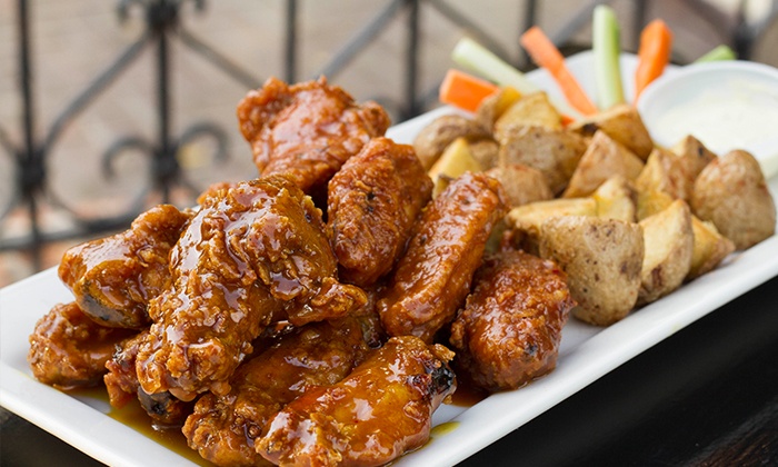 Tasty chicken wings with unskinned potatoes.