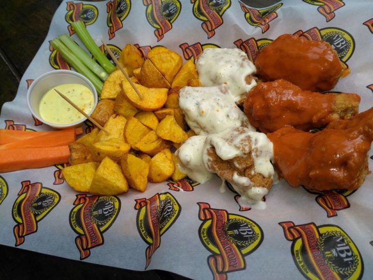MBF wings with buffalo hot sauce, blue cheese sauce, and golden brown potatoes