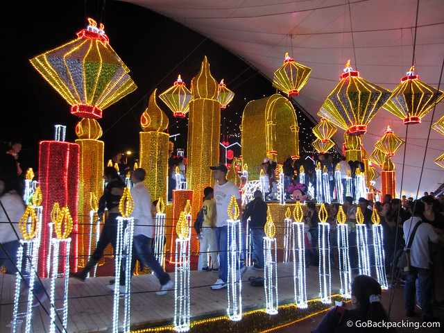 Virgin Mary display People line up to walk past a statue of the Virgin Mary at one of the riverside displays