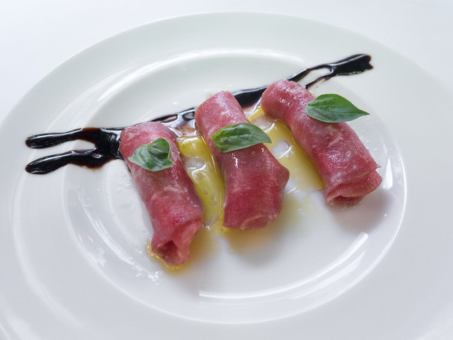 Beef carpaccio with cheese, basil, olive oil and balsamic vinegar