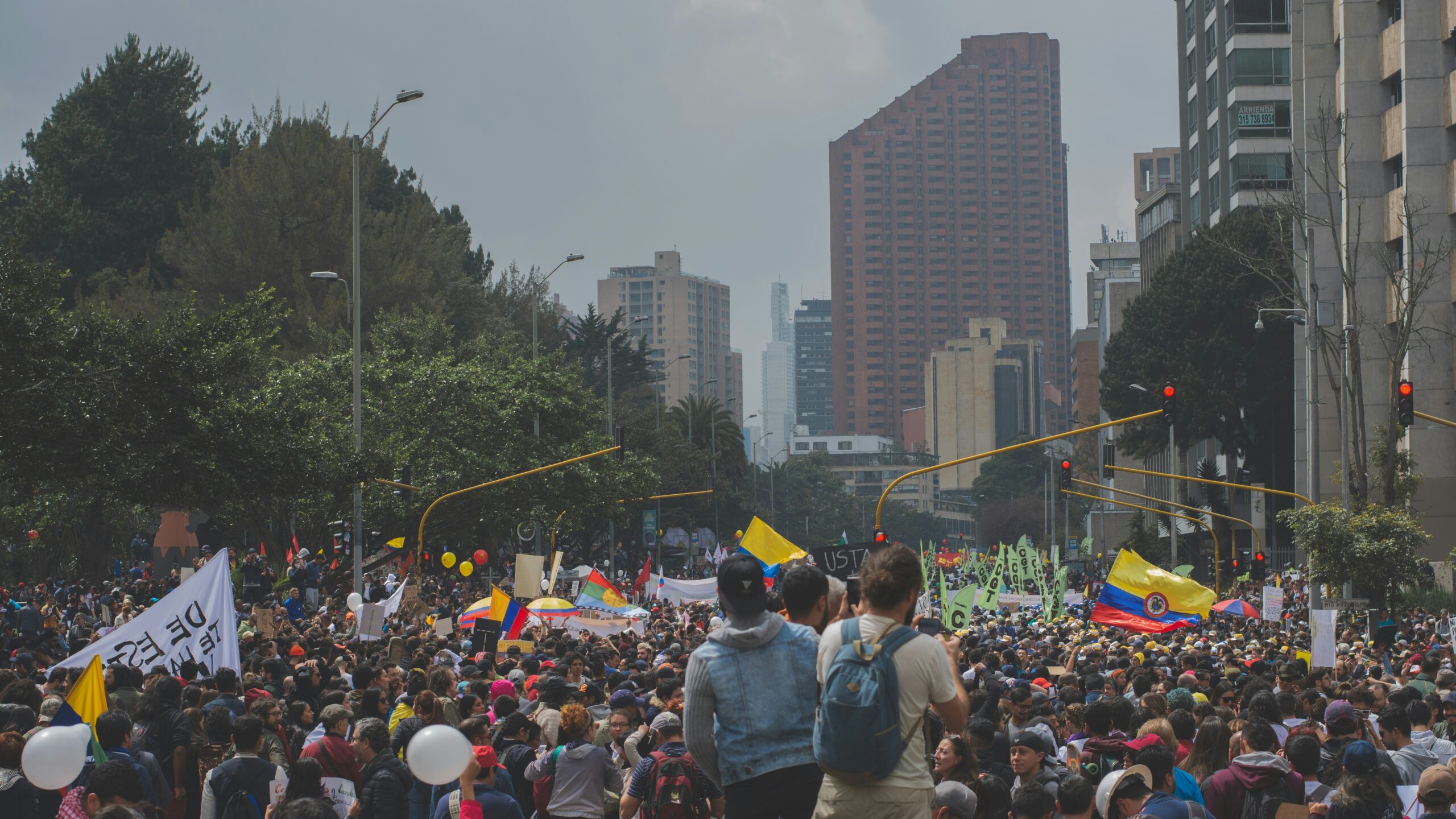 people protesting near buildings during daytime