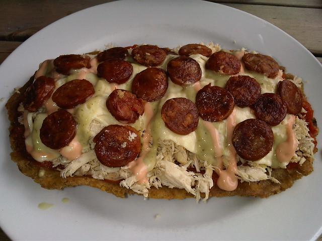Patacon con Pollo: shredded chicken, chorizo, guacamole, and pink salsa served atop fried plantains. Patacon con Pollo: shredded chicken, chorizo, guacamole, and pink salsa served atop fried plantains.