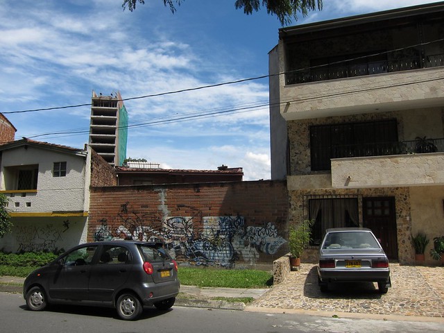 Pablo Escobar was killed running across the roof above the wall of graffiti on December 2, 1993