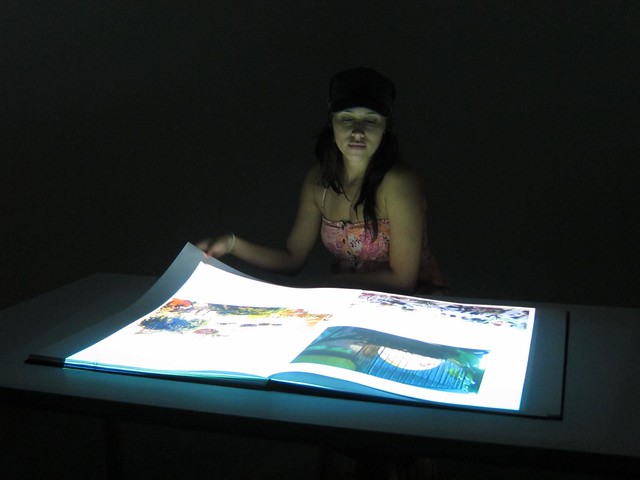 Carolina flips through illuminated pages