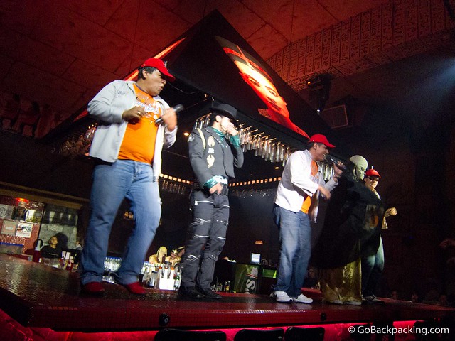 Singers get up on the bar to perform popular cover songs.