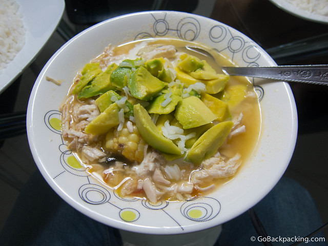 Ajiaco, ready to serve with white rice and fresh avocado