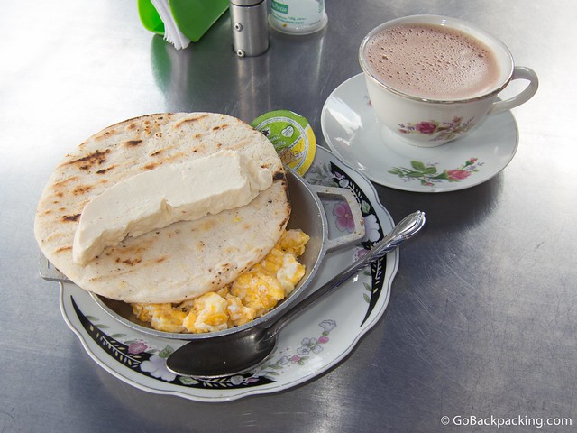 Arepa with eggs, cheese, and hot chocolate