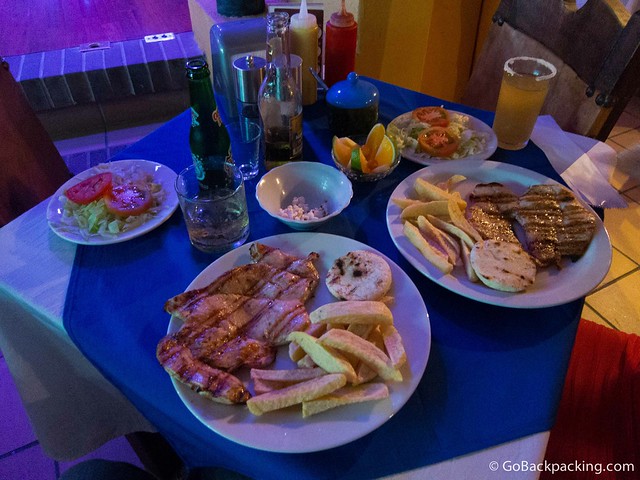 Chicken dishes with fries and side salads