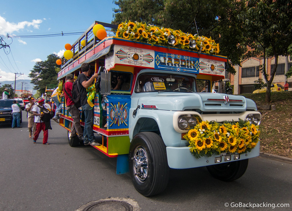 A TV crew jumps aboard the Jardin chiva as it begins driving the parade route