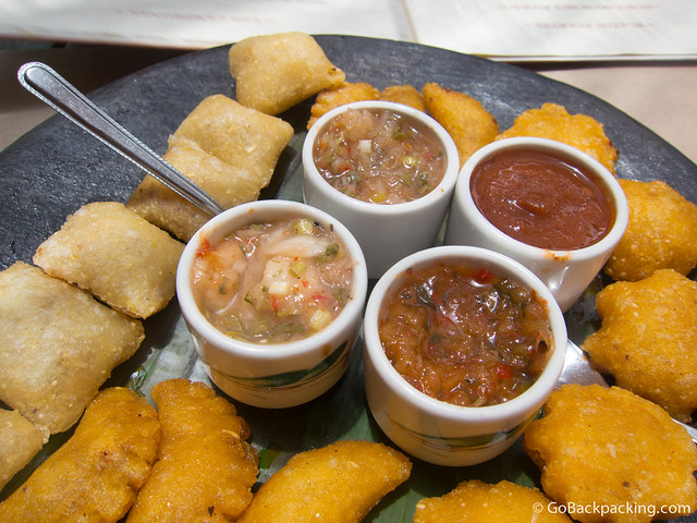 Three types of Colombian empanadas, with four types of fresh salsa